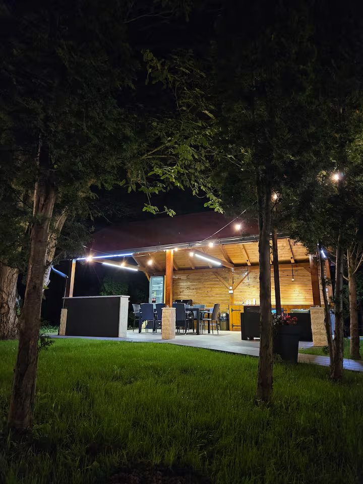 A-frame cabin front view at twilight with warm lighting