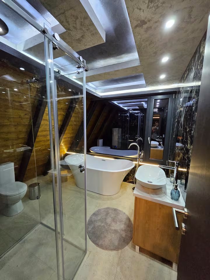 Bathroom area with jacuzzi view at night
