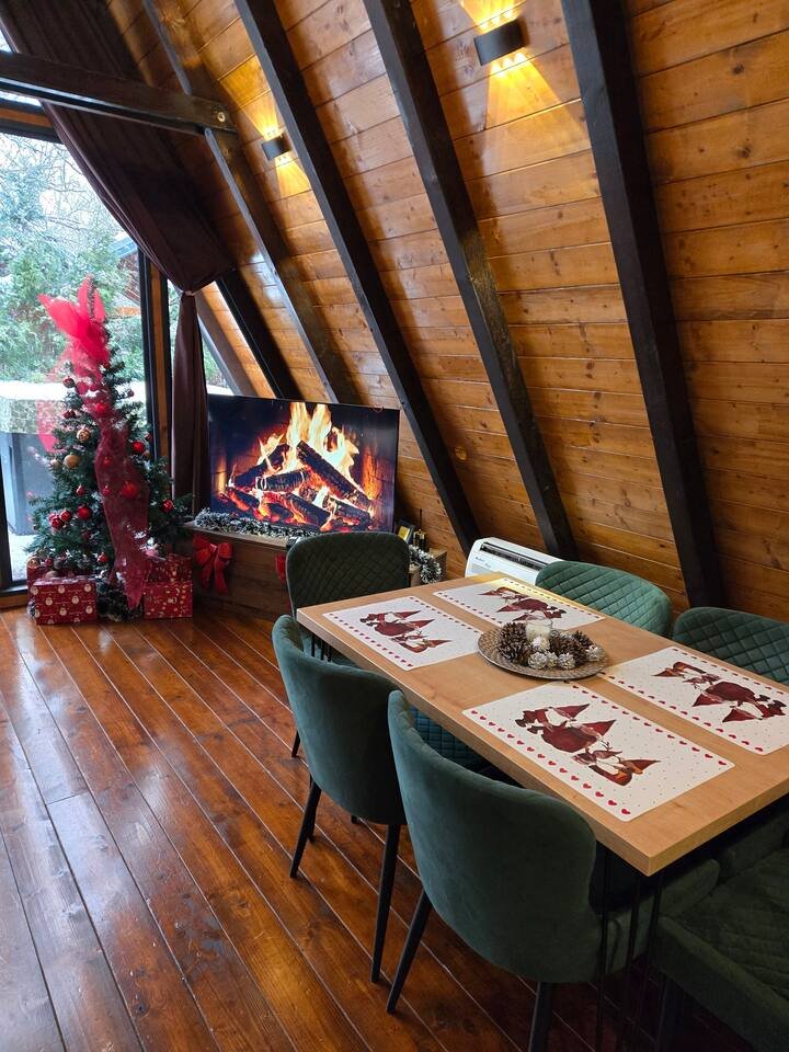 Cozy upper level interior with warm wooden beams