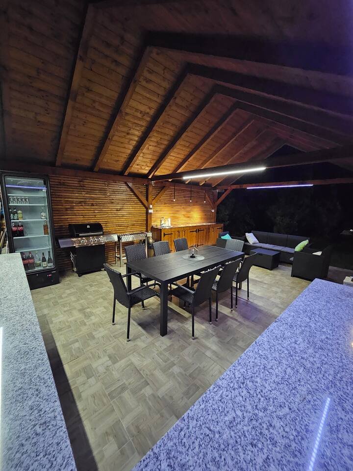 Pool area at night with string lights overhead