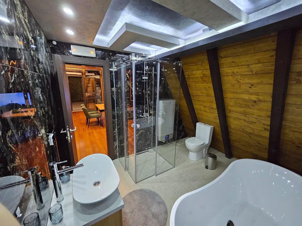 A-frame cabin glowing warmly on a snowy winter night